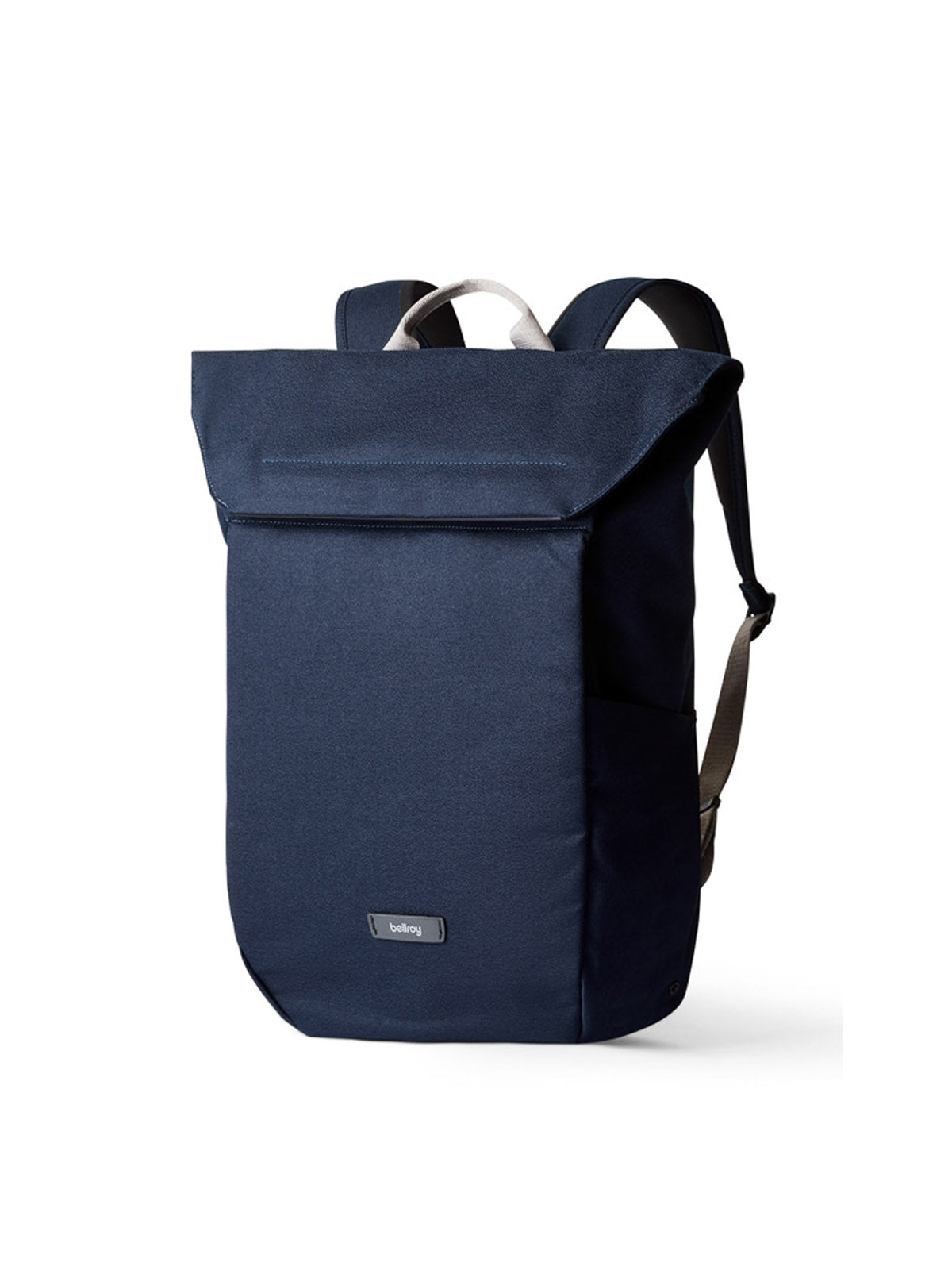 The Bellroy Melbourne Backpack - 18L is a navy minimalist bag featuring a top flap closure, adjustable shoulder straps, front pocket, and subtle logo patch near the bottom, displayed against a white background.