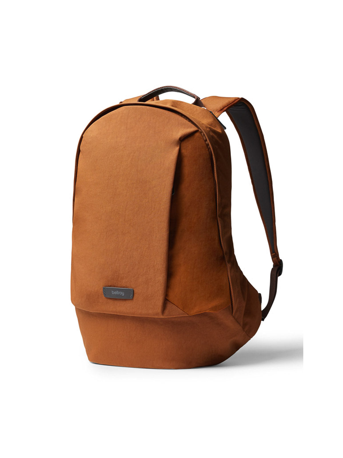 The Bellroy Classic Backpack - 20L is a rust-colored, minimalist urban bag made from recycled materials, featuring a front flap, subtle stitching, and a small rectangular logo tag. It stands upright against a white background.
