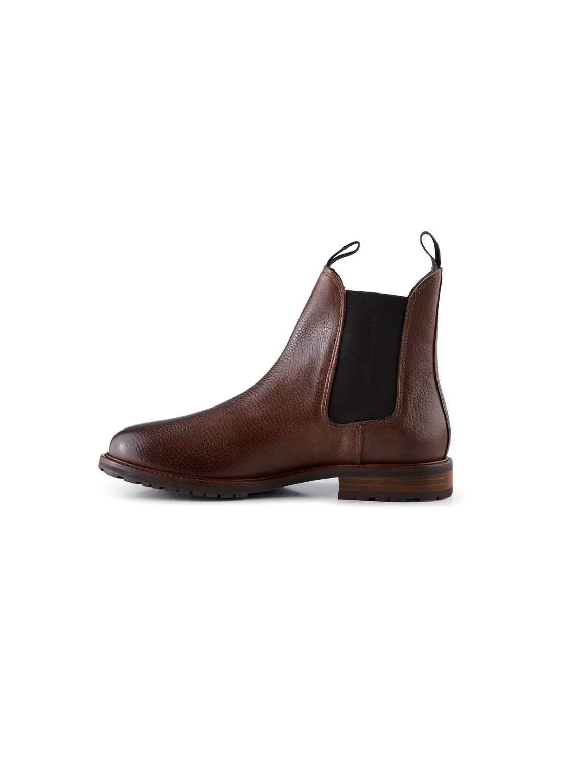 The York Classic Chelsea Boot by Shoe The Bear is made from LWG-certified brown leather with a textured finish, featuring black elastic side panels and front and back pull tabs. It includes a low heel and a flexible rubber outsole with tread. Shown is the right shoes side view.