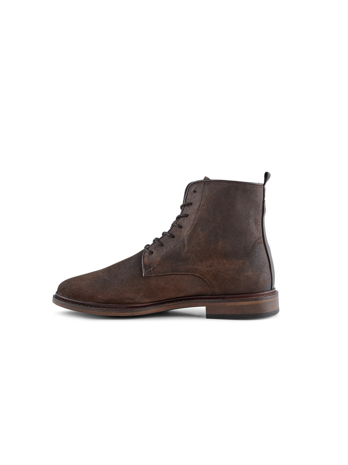 The Ned Suede Waxed Boot by Shoe The Bear is a brown leather lace-up ankle boot with a round toe and low stacked heel, featuring a slightly worn look. Handmade in Portugal, its shown from the side on a white background.