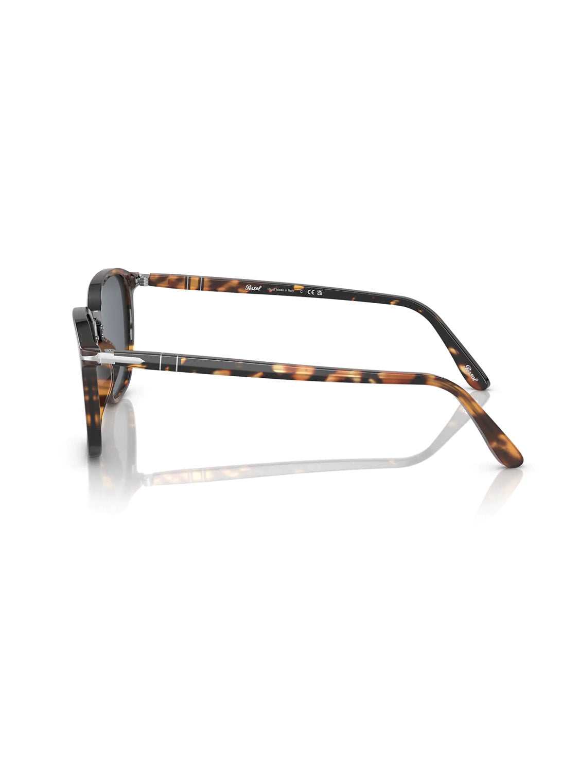 A side view of the Persol - PO3186 sunglasses showcases tortoiseshell acetate frames and thin arms with the Meflecto system for flexibility. Dark lenses reflect stylishly on a white surface, with metal accents near the hinges enhancing sophistication.