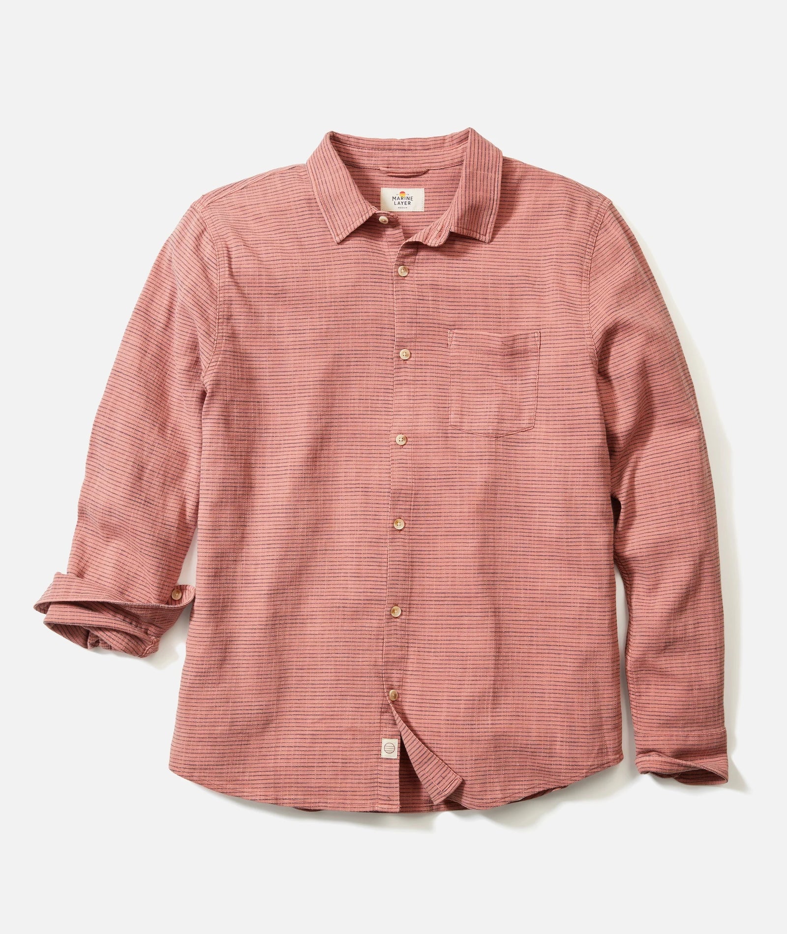 The Marine Layer Stretch Selvage Long Sleeve Shirt features muted red stripes, a chest pocket, rolled sleeves, and is crafted from soft stretch cotton. Shown on a white background.
