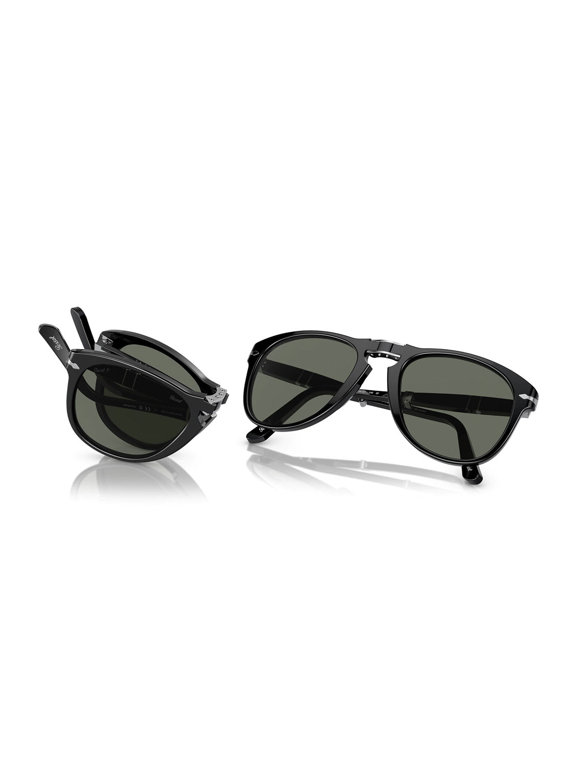 A pair of Persols PO714 sunglasses with sleek black frames displays its dark lenses on the right, arms open wide. On the left, another stylish set rests folded with an elegant acetate frame. Both exude sophistication against a pristine white background.