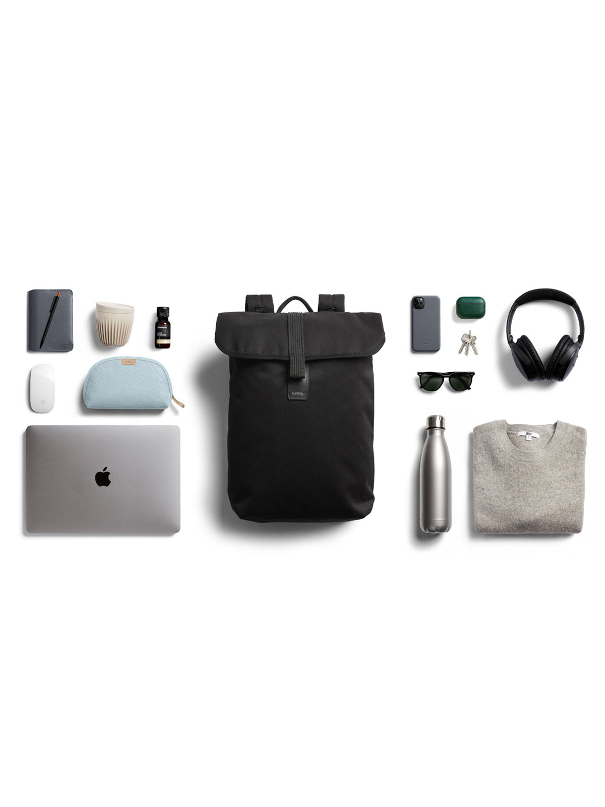 A neatly arranged flat lay features the Bellroy Oslo Backpack - 16L, along with a laptop, sweater, water bottle, headphones, sunglasses, phone, wallet, keys, charger, pen, notepad, and small pouches on a white background.