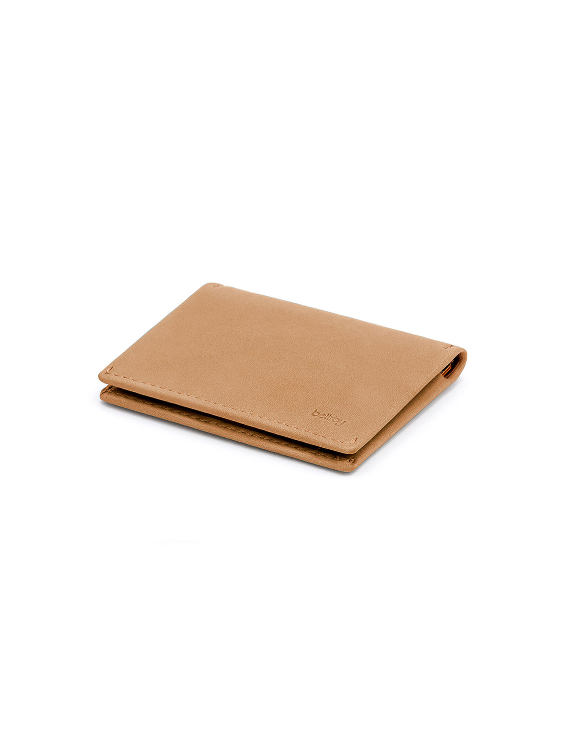 The Bellroy Slim Sleeve Wallet, crafted in tan leather, is shown closed on a white background, emphasizing its minimalist design and smooth finish.
