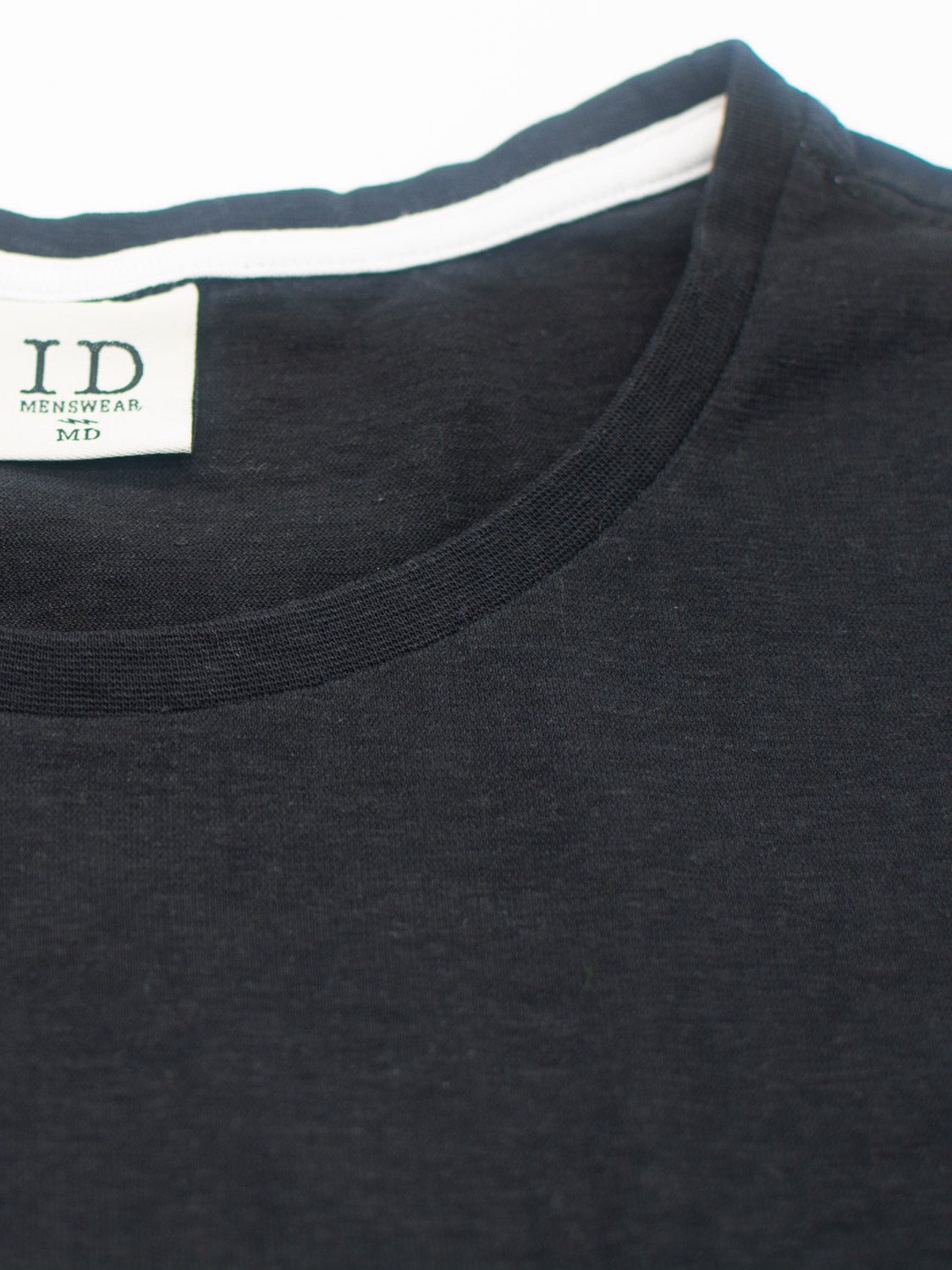Close-up of the neckline of a Dope Hemp Organic Cotton Tee by ID Menswear, featuring a white label inside. The black sustainable fabric T-shirt is displayed on a white background.