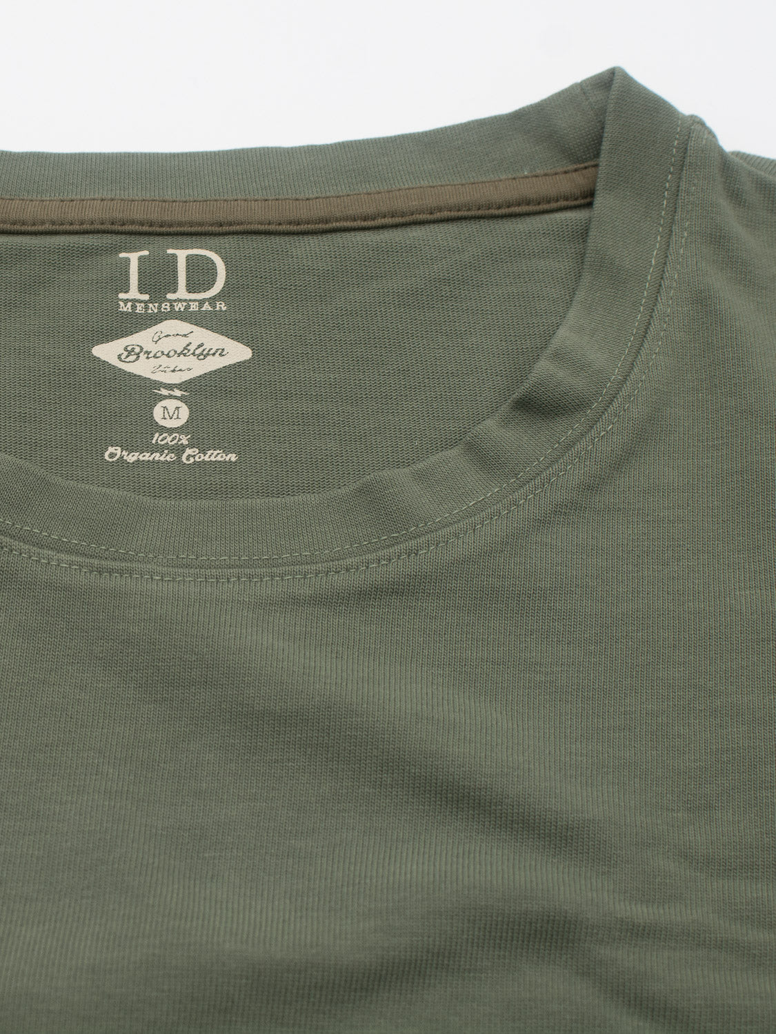 The City Organic Cotton Tee by ID Menswear offers a slim fit and visible stitching, featuring a printed inner label declaring ID Menswear, Brooklyn. Made from 100% organic cotton, it perfectly blends comfort with sustainable style.