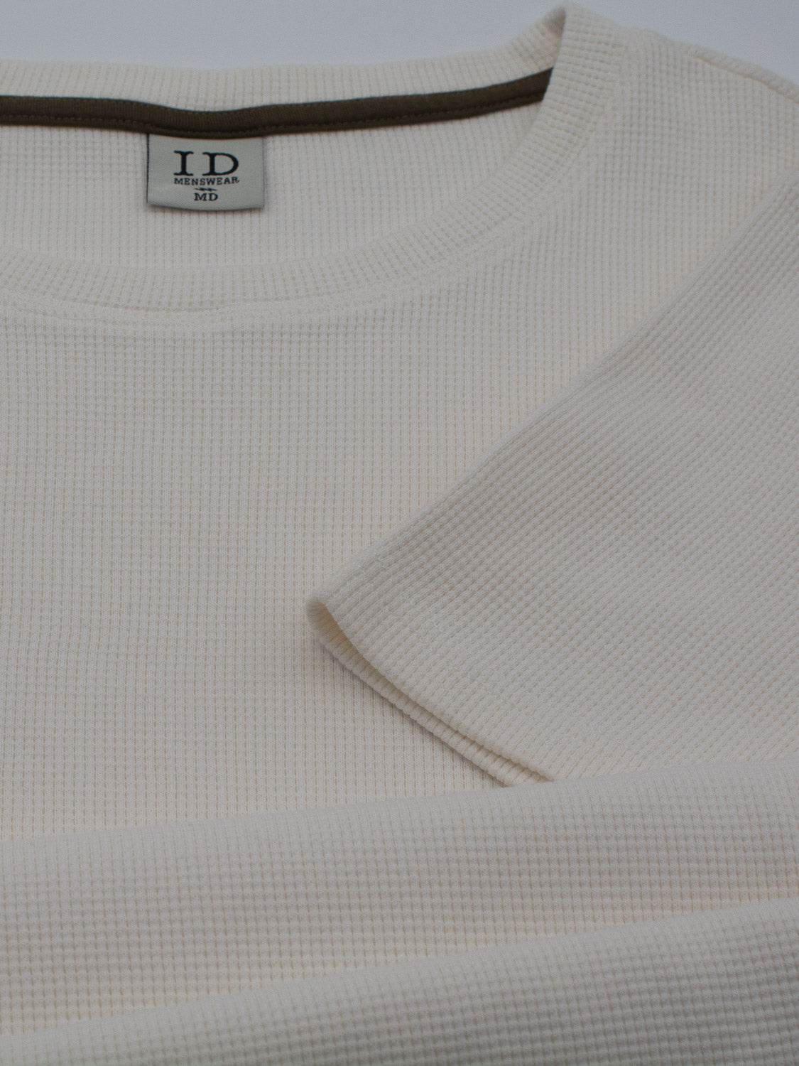 Close-up of the Urban Waffle Knit Tee in beige, featuring a round neckline and a visible ID Menswear tag reading Medium. The soft cotton-spandex blend with its ribbed texture is ideal for casual wear.