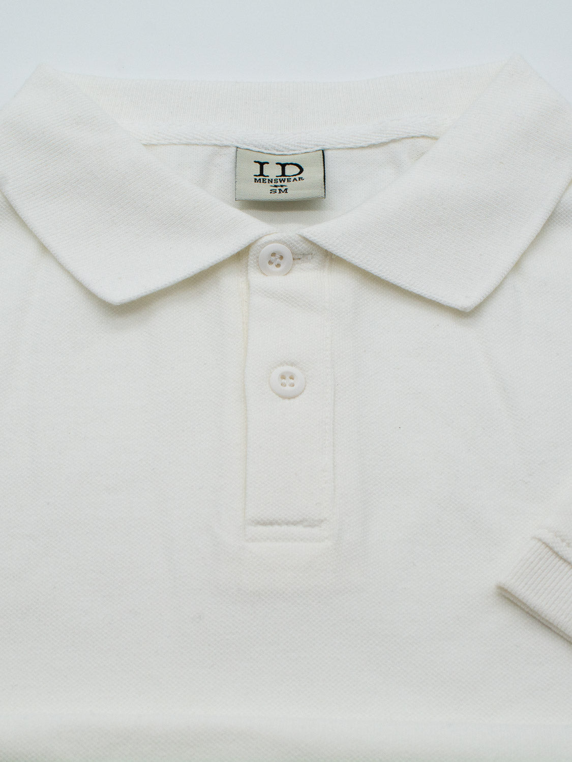 The Ranger Classic Cotton Mesh Polo by ID Menswear showcases classic style with a collared neckline and three buttons. Made from lightweight cotton for comfort and breathability, it neatly presents size info on a label inside the collar when laid flat.