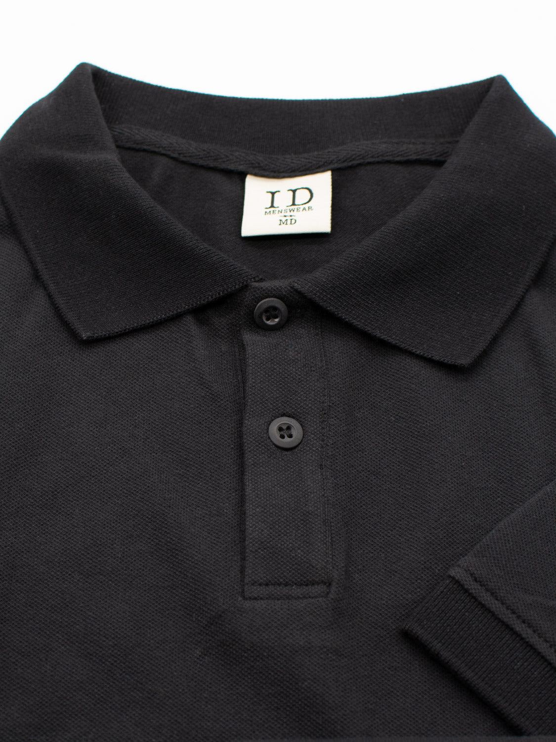 The Ranger Classic Cotton Mesh Polo from ID Menswear is crafted from lightweight cotton, showcasing a classic style with a folded collar and three-button placket. The black shirt features a neck tag labeled ID Menswear MD.