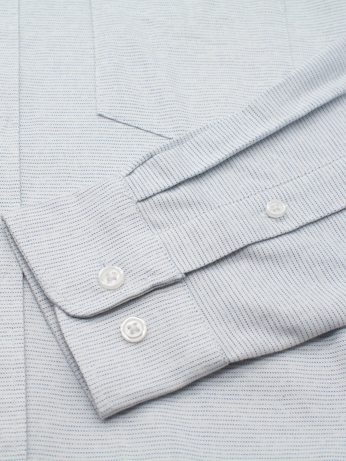 The Akira Cotton Button Down Shirt by ID Menswear is light blue with thin dark stripes, featuring a button-down collar, crisp fabric, and well-tailored design. It has buttoned cuffs with two white buttons each and a visible chest pocket edge.