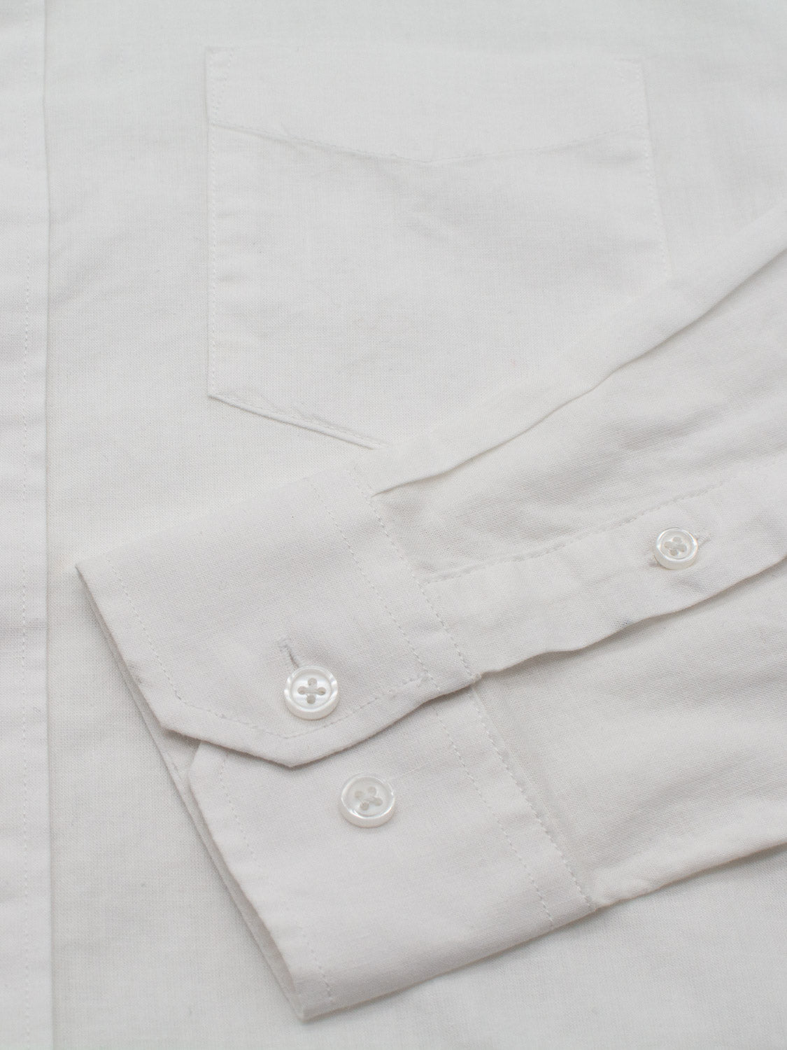 Close-up of an ID Menswear Goa Linen Cotton Long Sleeve Shirt, highlighting the horizontal sleeve with visible buttons on the cuff and a subtly outlined chest pocket against breathable fabric.