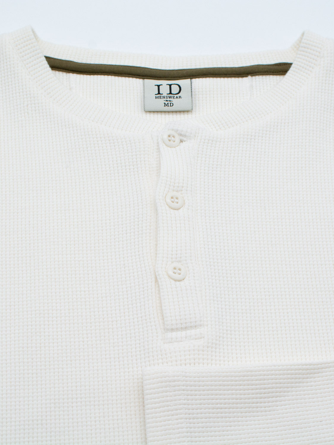 Close-up of the Freestyle Waffle Knit Henley by ID Menswear, featuring a white, waffle-knit design in a regular fit with green inside the collar. It has a short button placket with three white buttons and is made from a comfy cotton-spandex blend. A label inside reads I.D. MENS WEAR MD.