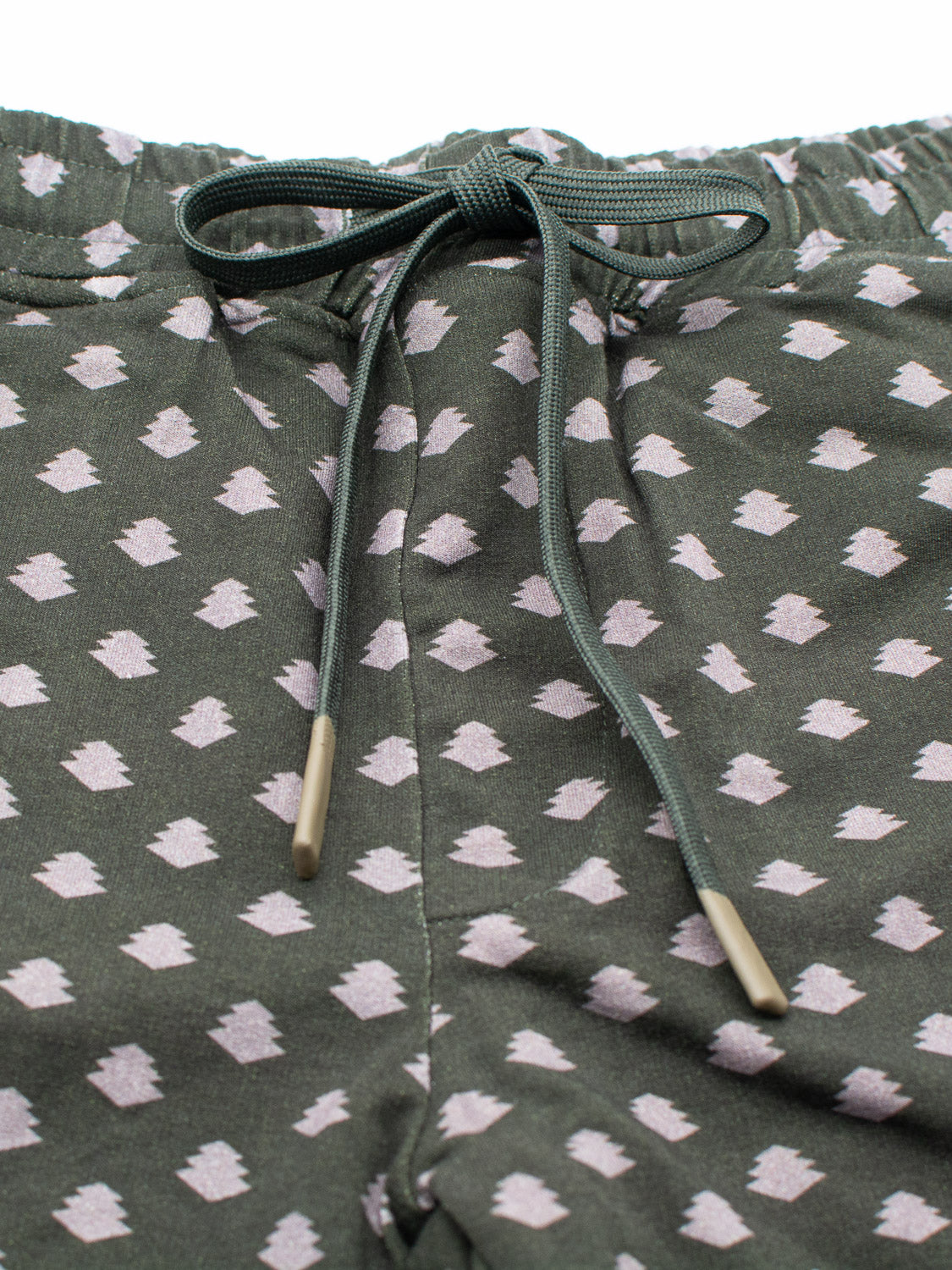 Close-up of the Samui Vintage Japanese Print Short by ID Menswear, crafted from green organic cotton with a pattern of light pink abstract shapes inspired by vintage Japanese prints and a bow-tied drawstring waist.