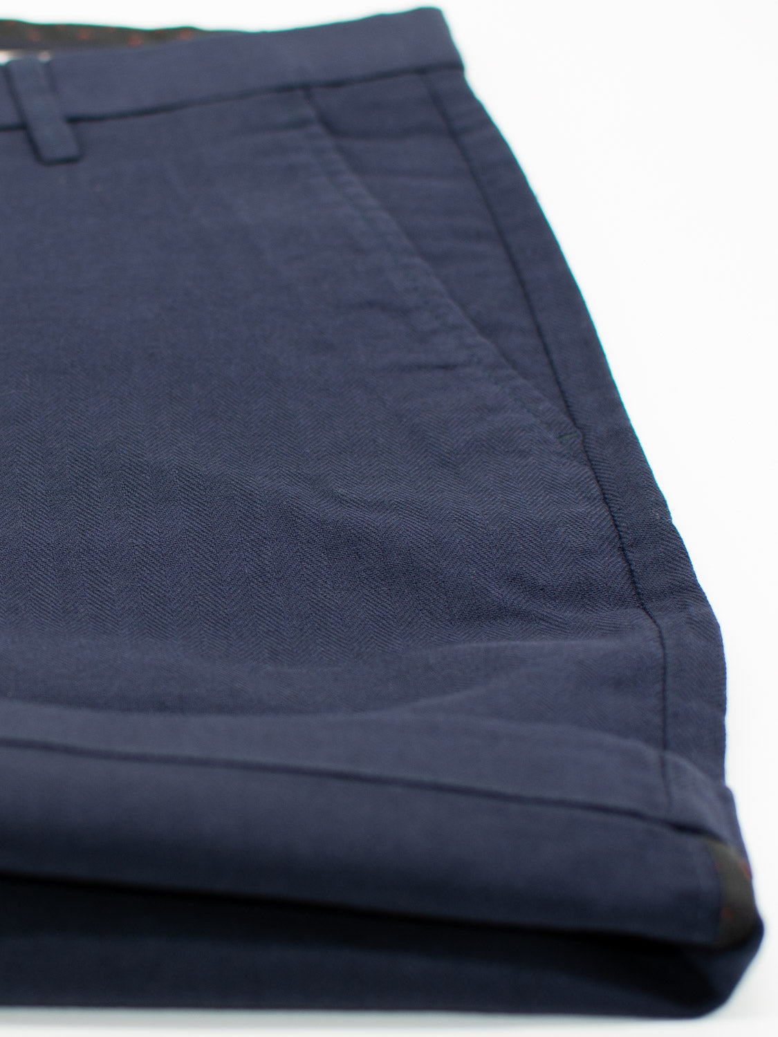 The Kerala Linen Blend Chino Short by ID Menswear is displayed on a white background. It features a dark blue, smooth linen-cotton fabric with a visible side pocket and belt loop, offering a relaxed fit.