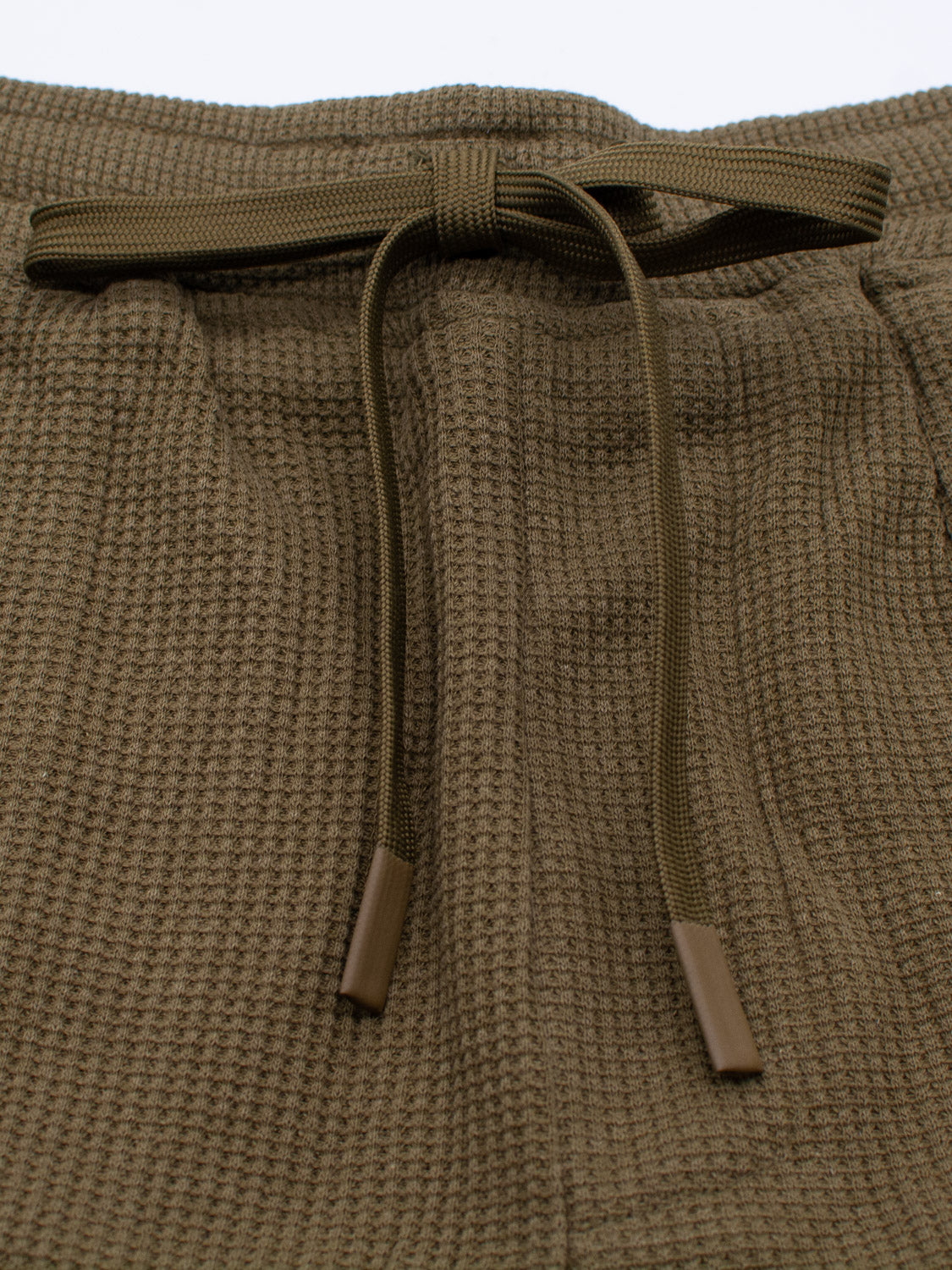 Close-up of ID Menswears Walker Waffle Knit Short, showcasing the texture with a centered tied bow and coated drawstring ends.