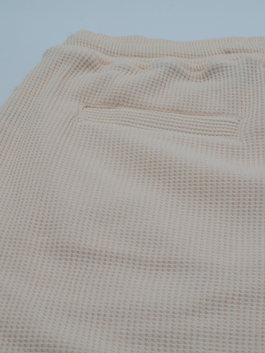 Close-up of ID Menswears Walker Waffle Knit Short in light beige, featuring a single back pocket. The waffle-knit texture is visible, highlighting the soft and comfortable fabric.