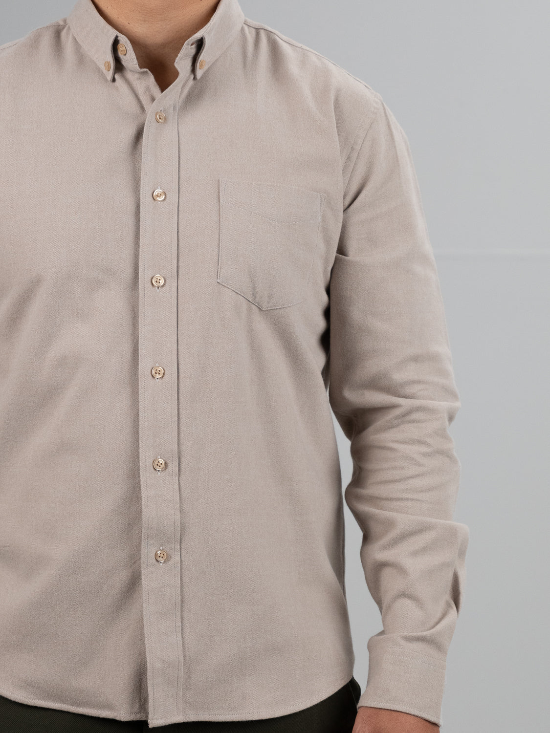 A person wearing the ID Menswear Rex Cotton Sustans Blends Flannel Shirt in light beige, featuring a chest pocket, stands against a plain light gray background. Only the upper body is visible.