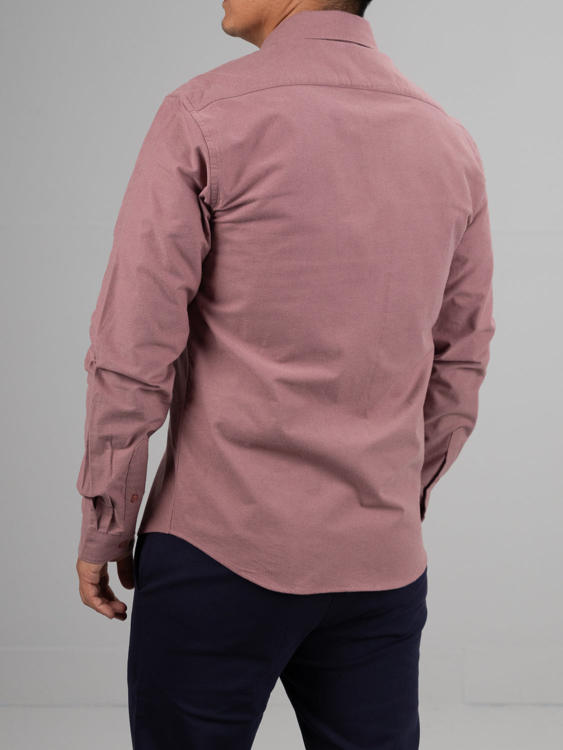 A person wearing the Milo Brushed Oxford Flannel Cotton Shirt by ID Menswear in pink and navy pants stands against a plain gray background, seen from the back.