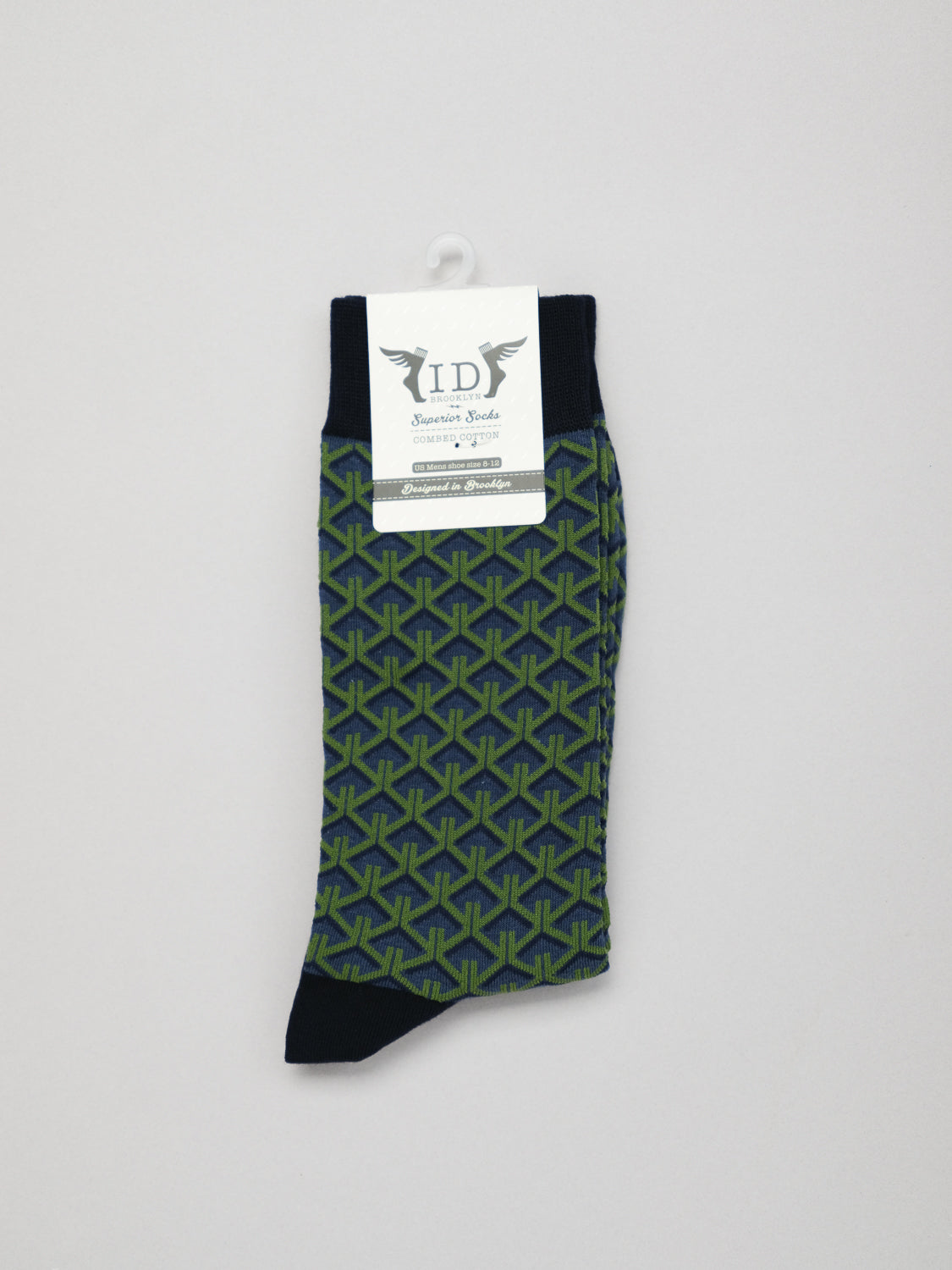 A single Wagara Graphic Sock, featuring a black, blue, and lime geometric pattern inspired by Japanese designs, hangs with a white ID Menswear label. The sock has black toe, heel, and cuff.
