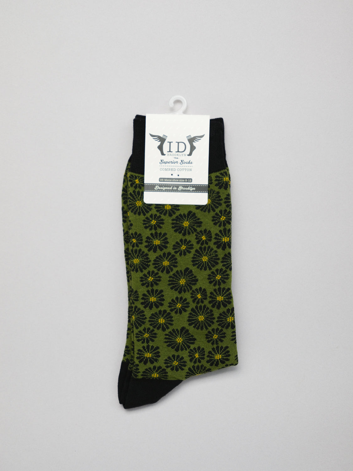 Beckia Graphic Socks by ID Menswear, in green and black floral pattern, are shown on a plain background. Made from premium combed cotton for breathability and comfort, they feature a brand tag on top.