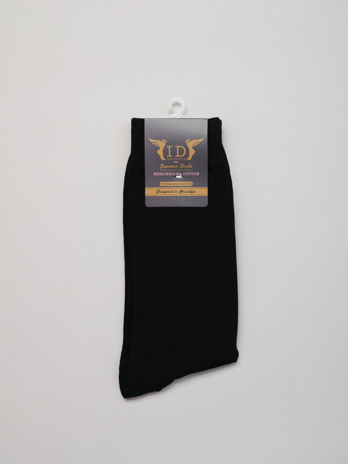ID Menswears Mercerized Cotton Socks, crafted from breathable fabric, are neatly folded and packaged against a white background. The package features a label with text and a winged logo.