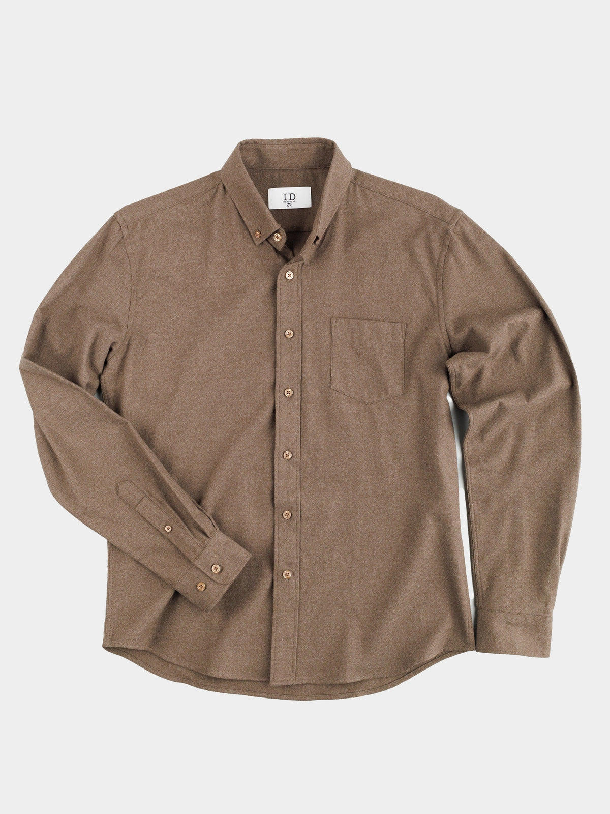 The Rex Cotton Sustans Blends Flannel Shirt by ID Menswear is a brown, long-sleeve button-up with a buttoned collar, single chest pocket, and matching brown buttons, made from sustainable fabric, shown laid flat on a white background.