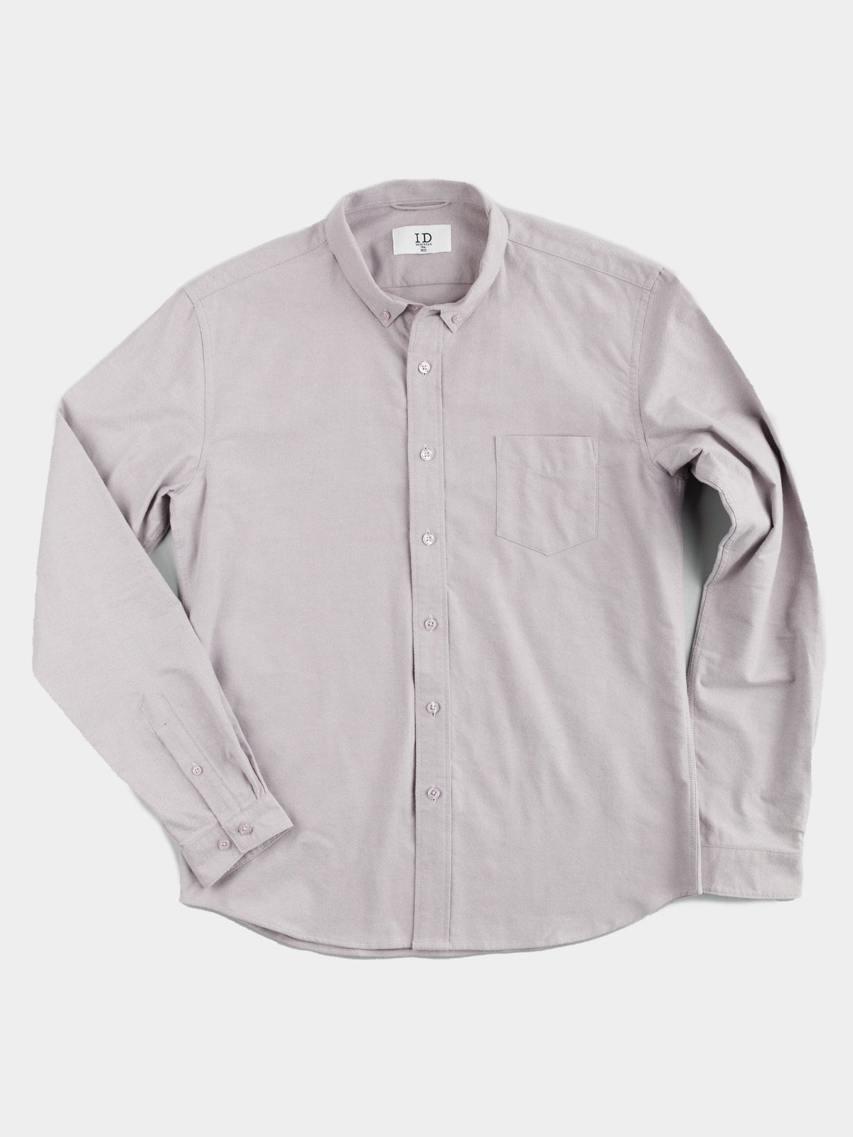 The Milo Brushed Oxford Flannel Cotton Shirt by ID Menswear is a versatile light gray shirt with long sleeves, a button-up front, collar, and chest pocket, shown on a white background.