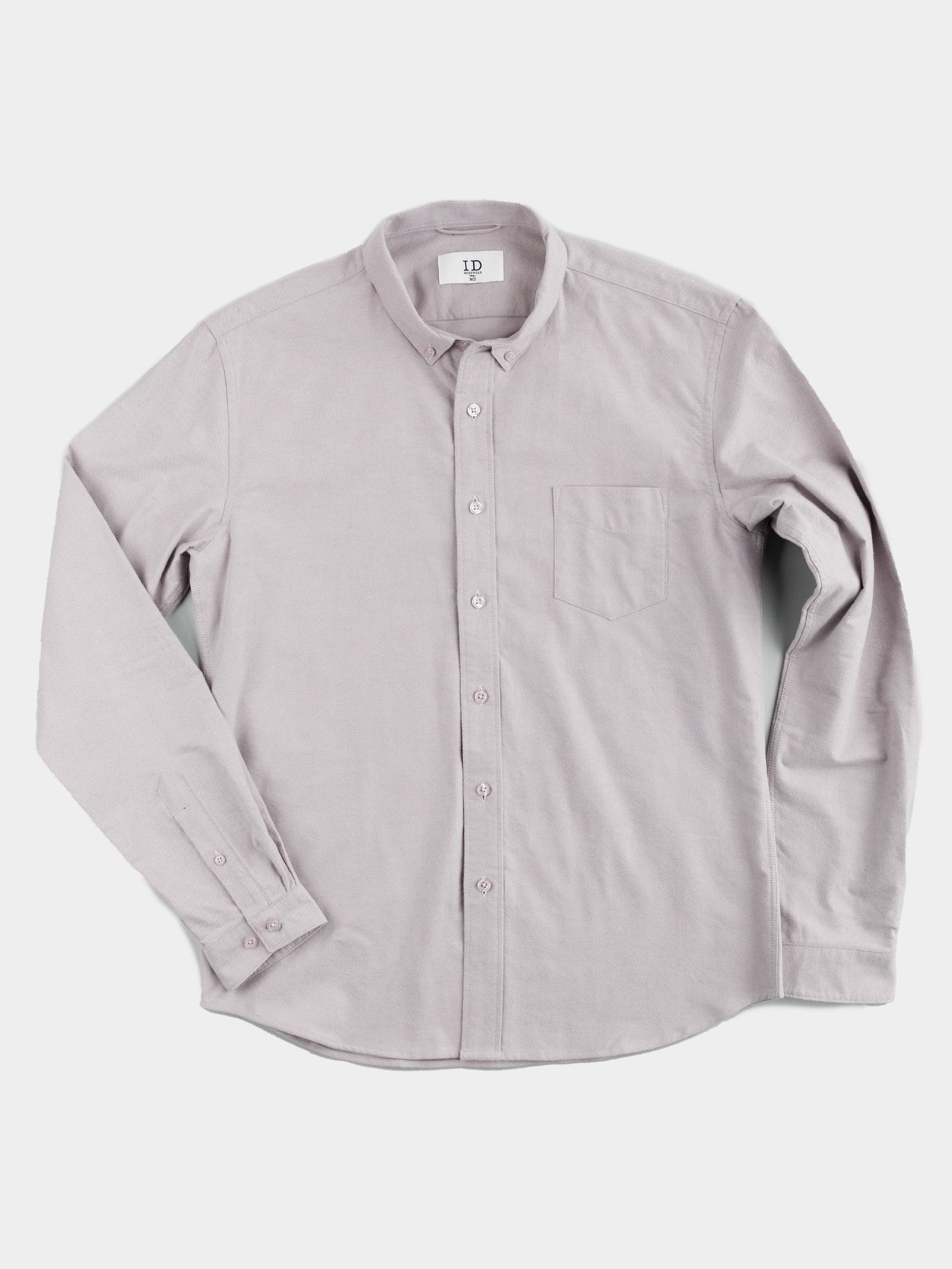 The Milo Brushed Oxford Flannel Cotton Shirt by ID Menswear is a versatile light gray shirt with long sleeves, a button-up front, collar, and chest pocket, shown on a white background.