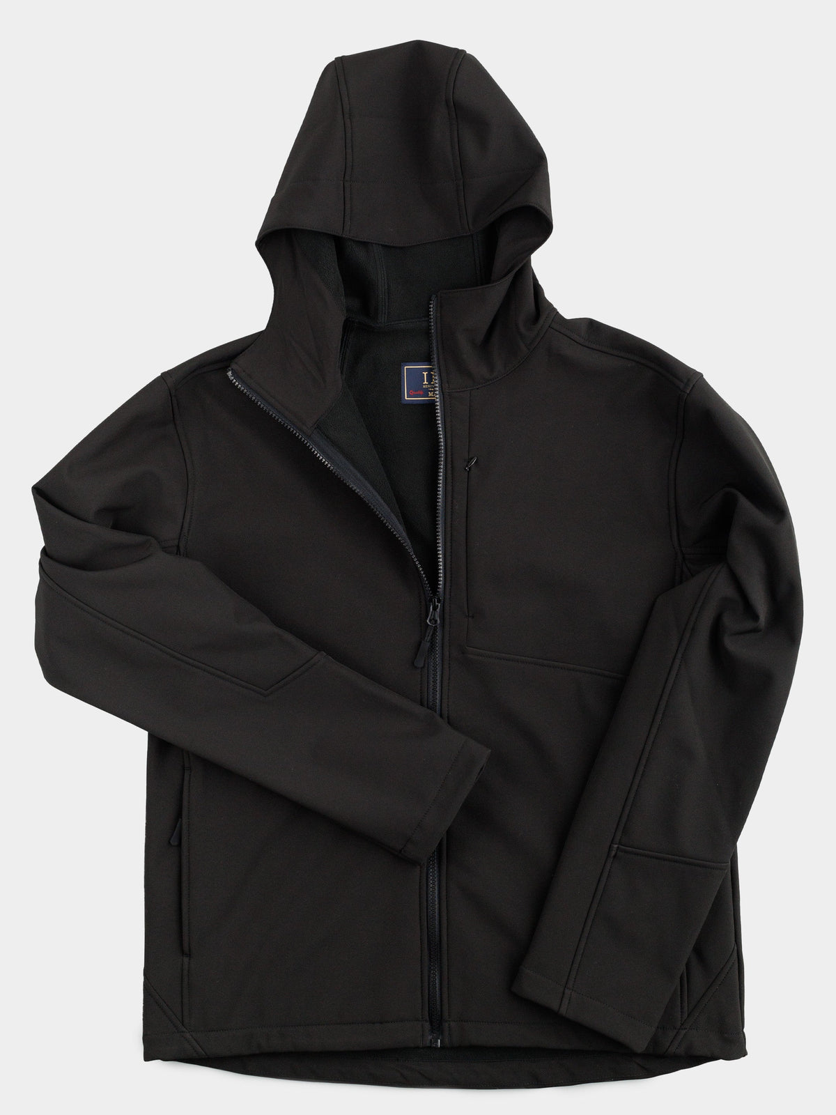 The Fairbanks Soft Shell Hooded Jacket by ID Menswear is a black, lightweight jacket with a front zipper, two front pockets, and an extra chest pocket. It’s shown on a white background and features smooth material with an upright hood; one sleeve is partly folded over the torso.