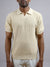 A man models the Mecca Linen Blend Knit Polo by ID Menswear with light-colored pants against a plain gray background; his face is partially out of frame, arms resting casually at his sides.