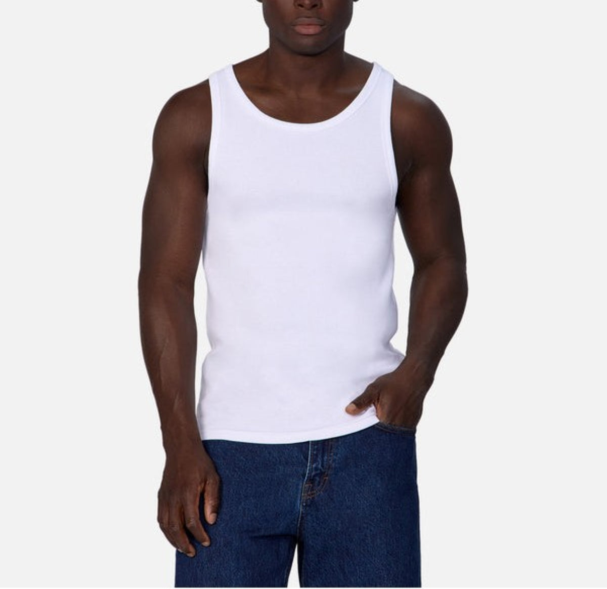 A man models the Industrie Washed Brando Ribbed Tank Top with blue jeans against a light gray background, highlighting this slim fit essential for your summer wardrobe.