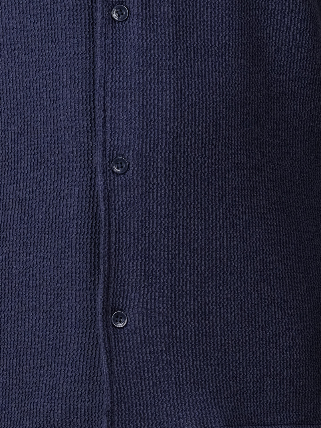 Close-up of the Archer SS RC Knitted Shirt by Casual Friday, showcasing its navy waffle-knit texture and three dark front buttons—timeless details of this stylish resort-collar button-up.