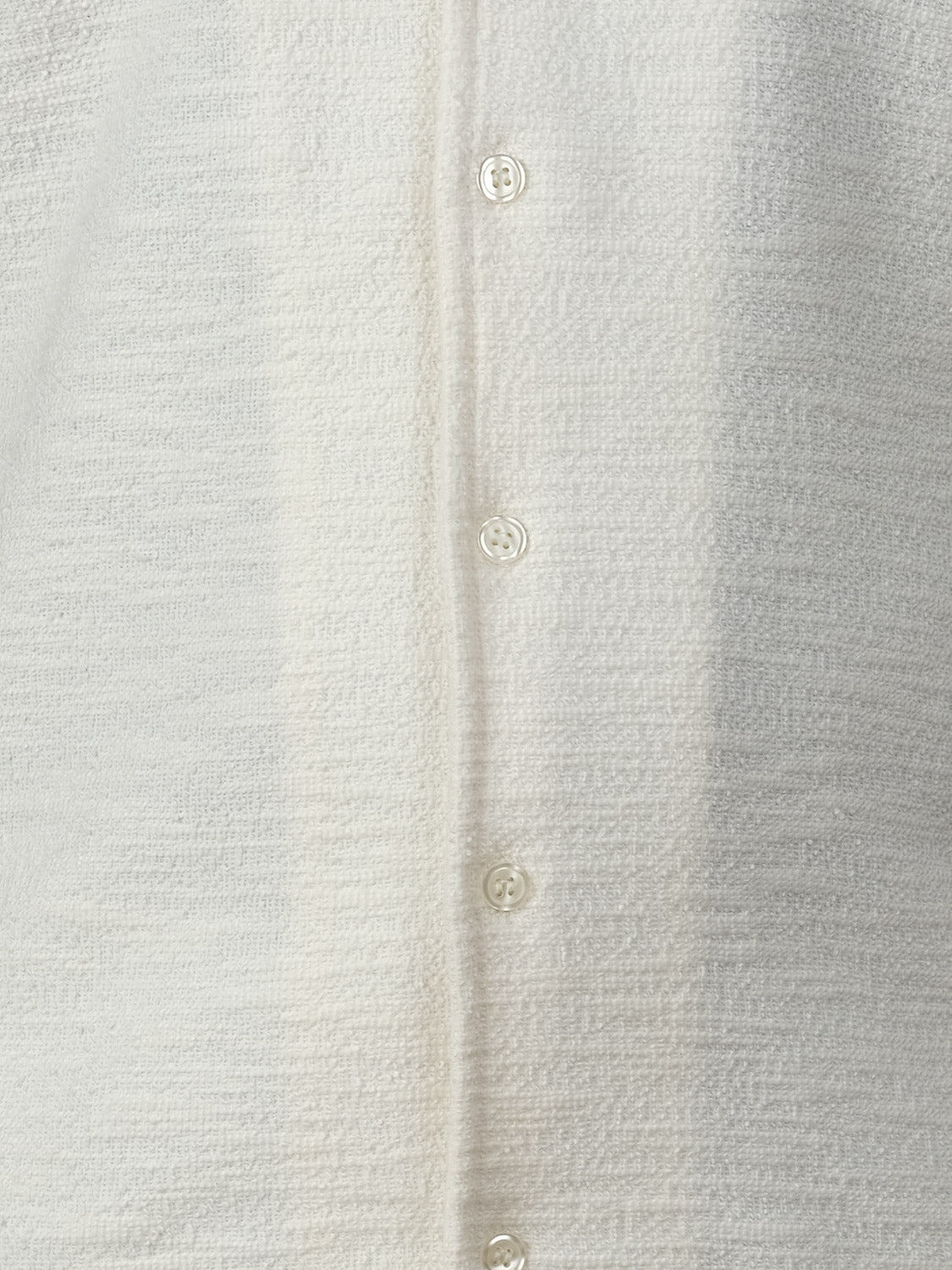 Close-up of the Egebjerg Resort Shirt by Casual Friday, a short-sleeved off-white cotton-polyester shirt featuring four small white round buttons and a subtle woven texture that gives it a slightly rough look.