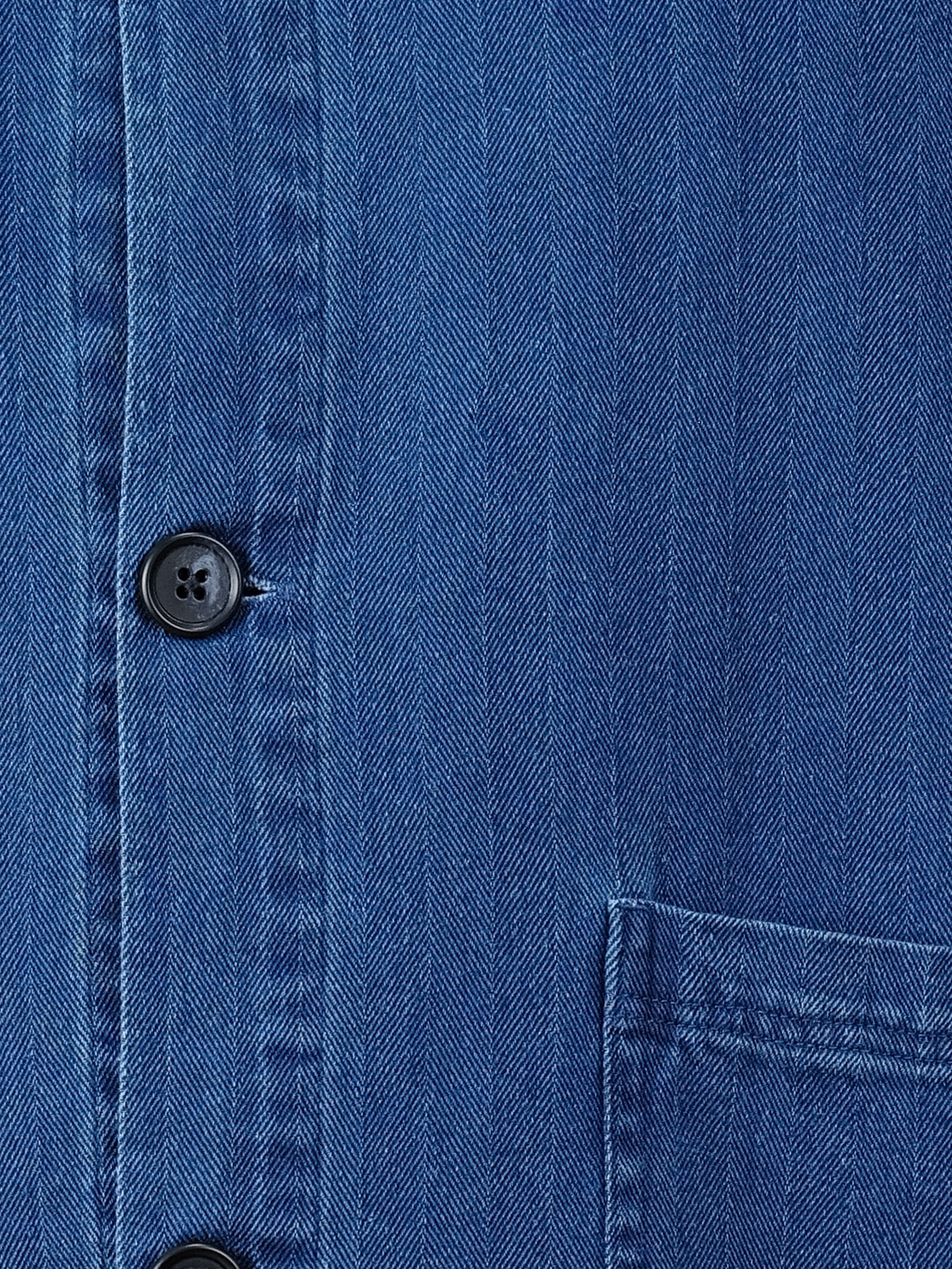 Close-up of the Asplund Herringbone Jacket by Casual Friday, showcasing vertical stitching, black buttons, and part of a front pocket—perfect for layering or pairing with your favorite casual blazer.