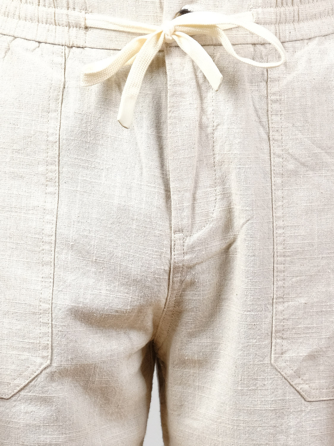 Close-up of the Sahara Linen Cotton Pant by ID Menswear in beige, featuring a relaxed fit, drawstring waist, front pockets, and visible linen-cotton blend texture with detailed stitching.