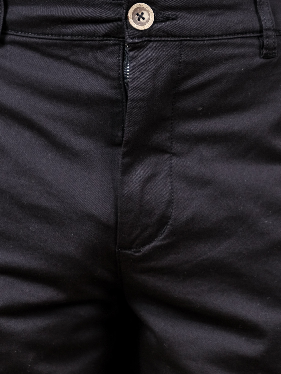 Close-up of the front of the Bishop Short by !Solid, featuring a buttoned waistband and a partially visible zipper. The regular fit offers smooth, fitted fabric for a polished look.