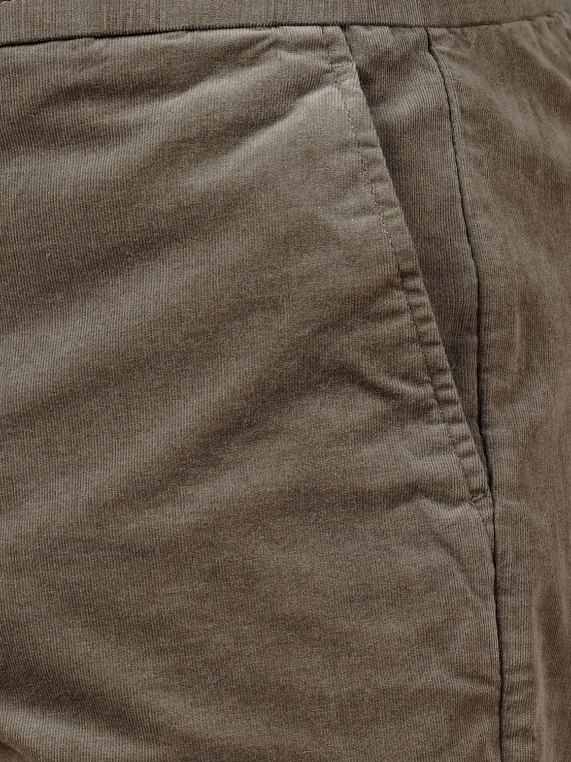 Close-up of the Odyssey Corduroy Stretch Short by ID Menswear, featuring brown corduroy fabric, a side pocket, elastic waistband, and visible stitching for a casual style. Fabric texture and seam details are clearly highlighted.