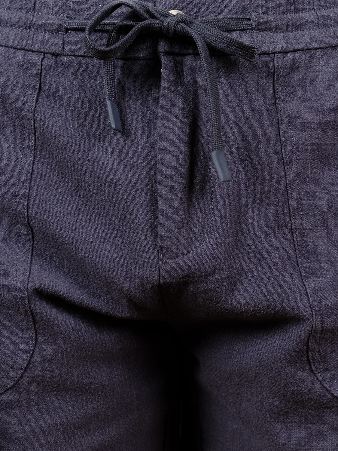 Close-up of the elastic waistband and upper section of the Phi Phi Linen Blend Drawstring Short by ID Menswear, highlighting its textured fabric, front seam, and two pockets.