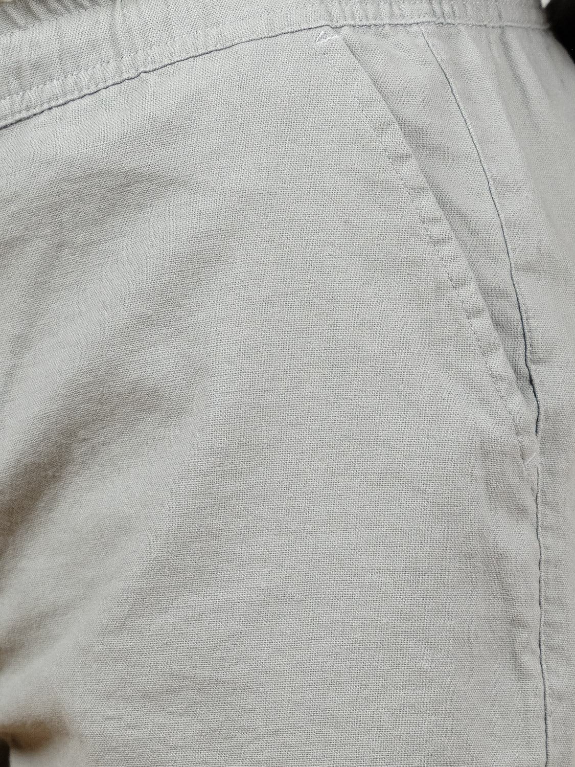 Close-up of the side pocket and waistband of the ID Menswear Kotao Linen Blend Drawstring Short in light beige, showcasing its textured fabric and detailed stitched seams.