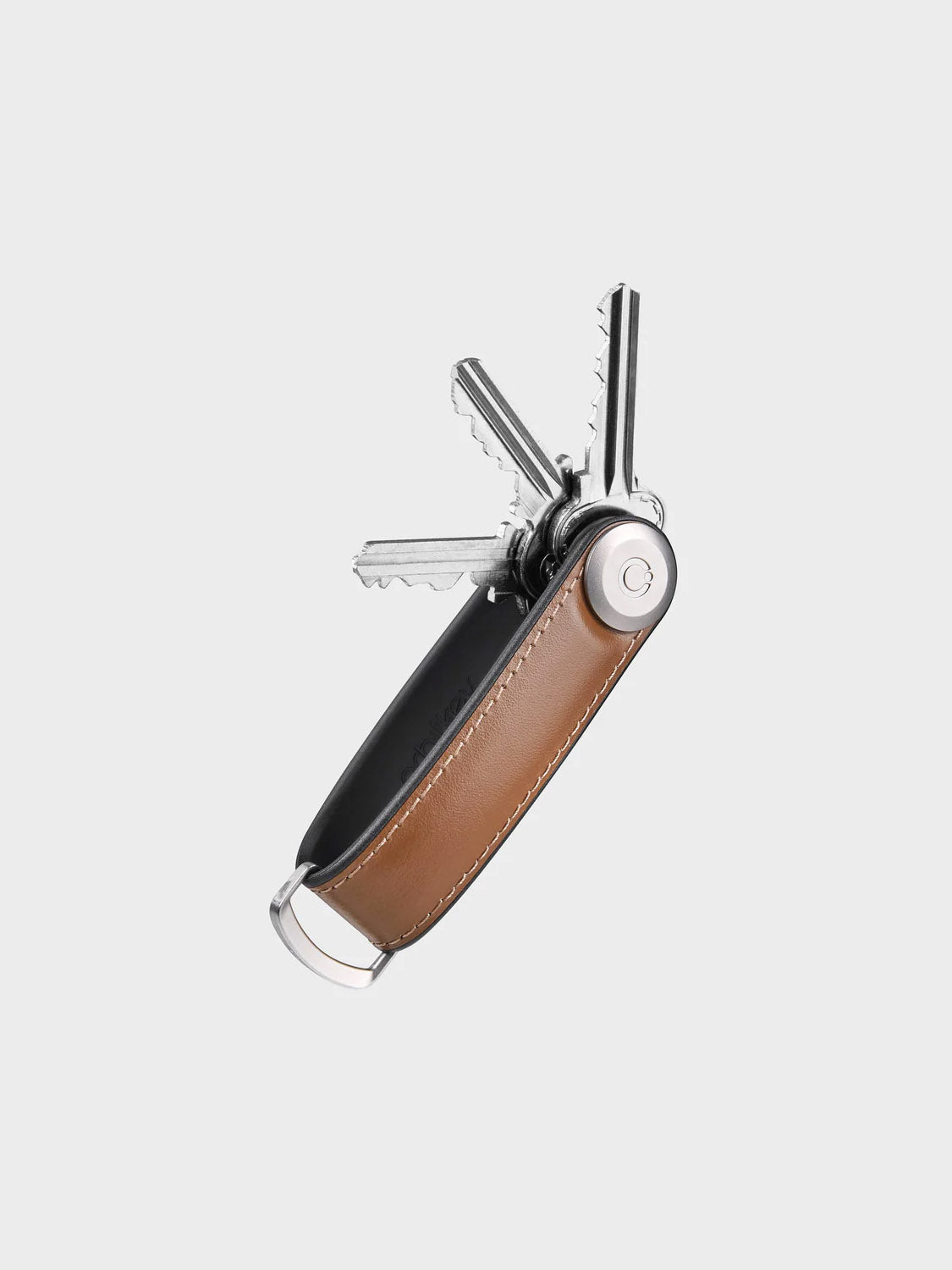 The Orbitkeys Key Organizer Hybrid Leather features a brown Nappa leather cover, a secure locking mechanism, and a metal frame that neatly stacks silver keys. Keys fan out smoothly, and a ring at one end offers added convenience.