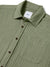 A close-up of the Katin Alan Solid Shirt in olive green, featuring a front pocket, brown buttons, and a Heist tag inside the collar. Crafted from quality materials by Katin and displayed flat against a white background to show its versatile style.