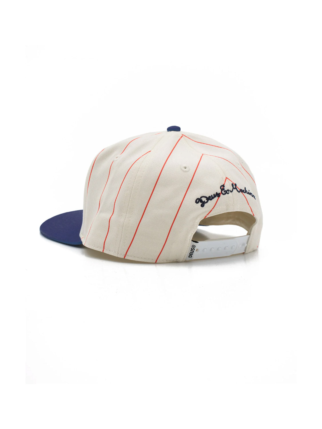 The Deus Alvia Cap is a cream cotton twill vintage baseball hat with thin red pinstripes, a navy blue brim, adjustable white snapback, and black and red embroidered text on the back.