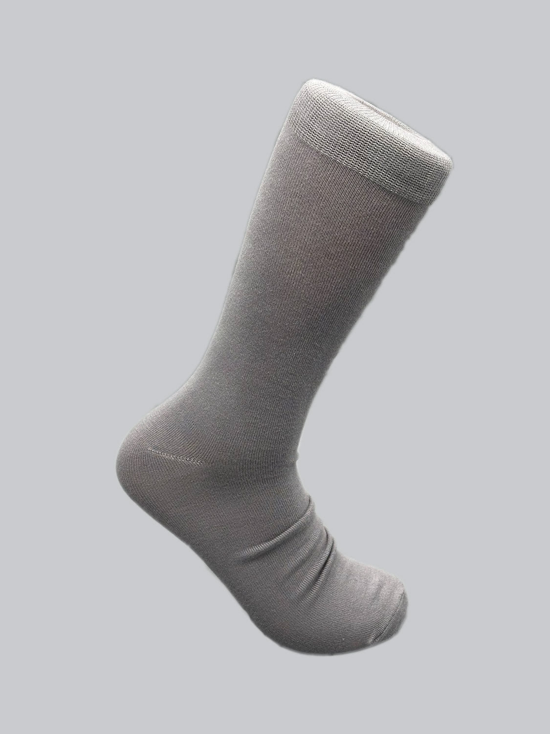 The Cylinder Knit Bamboo Solid Sock by ID Menswear, shown against a light gray background, is crafted from eco-friendly, smooth materials. It offers an extended cuff and subtle texture for enhanced comfort and breathability.