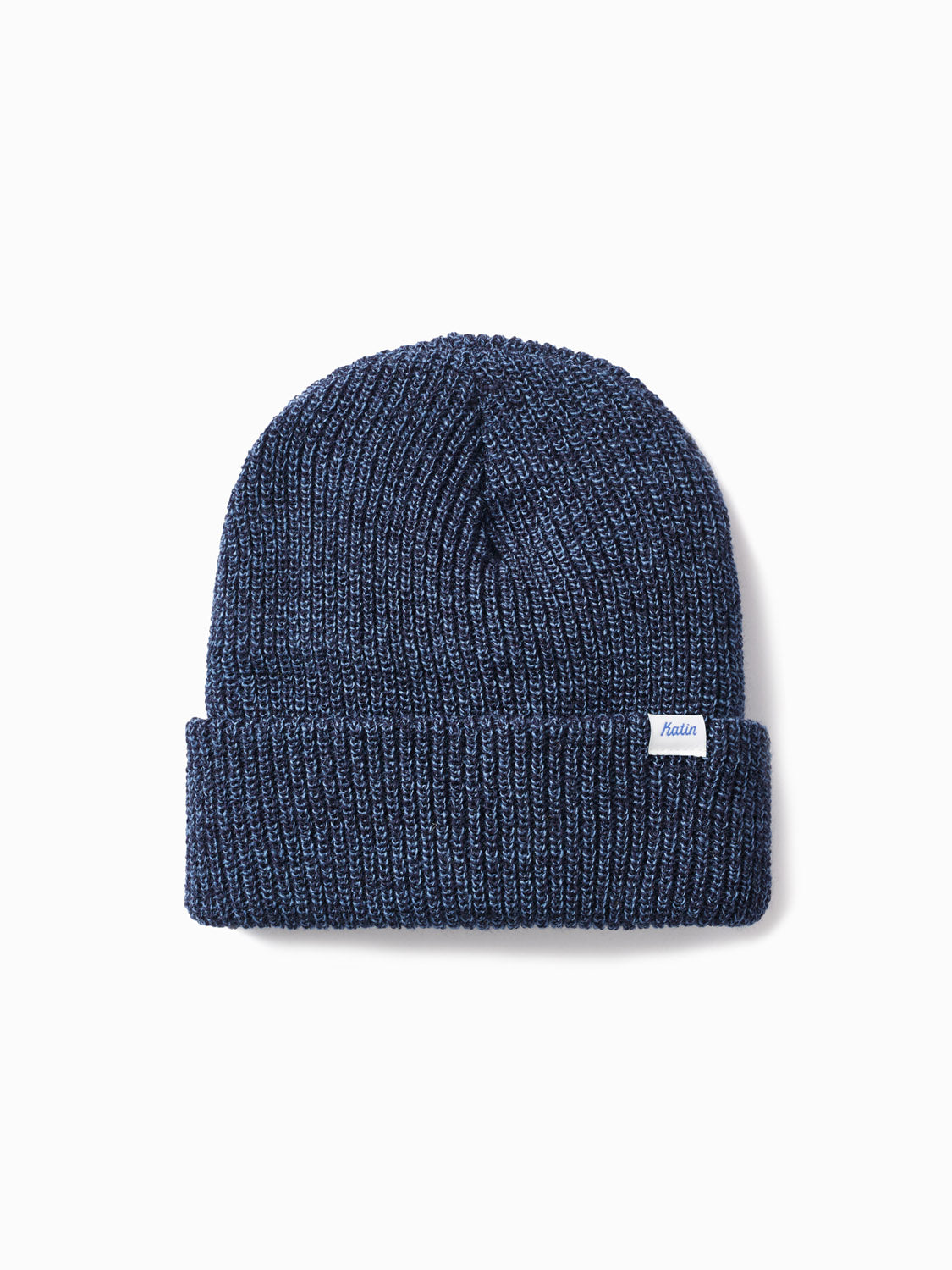 The Katin Basic Beanie is a navy blue cuff beanie with a folded edge and small white fabric front tag, shown on a plain white background. This classic watch cap offers timeless warmth and comfort.