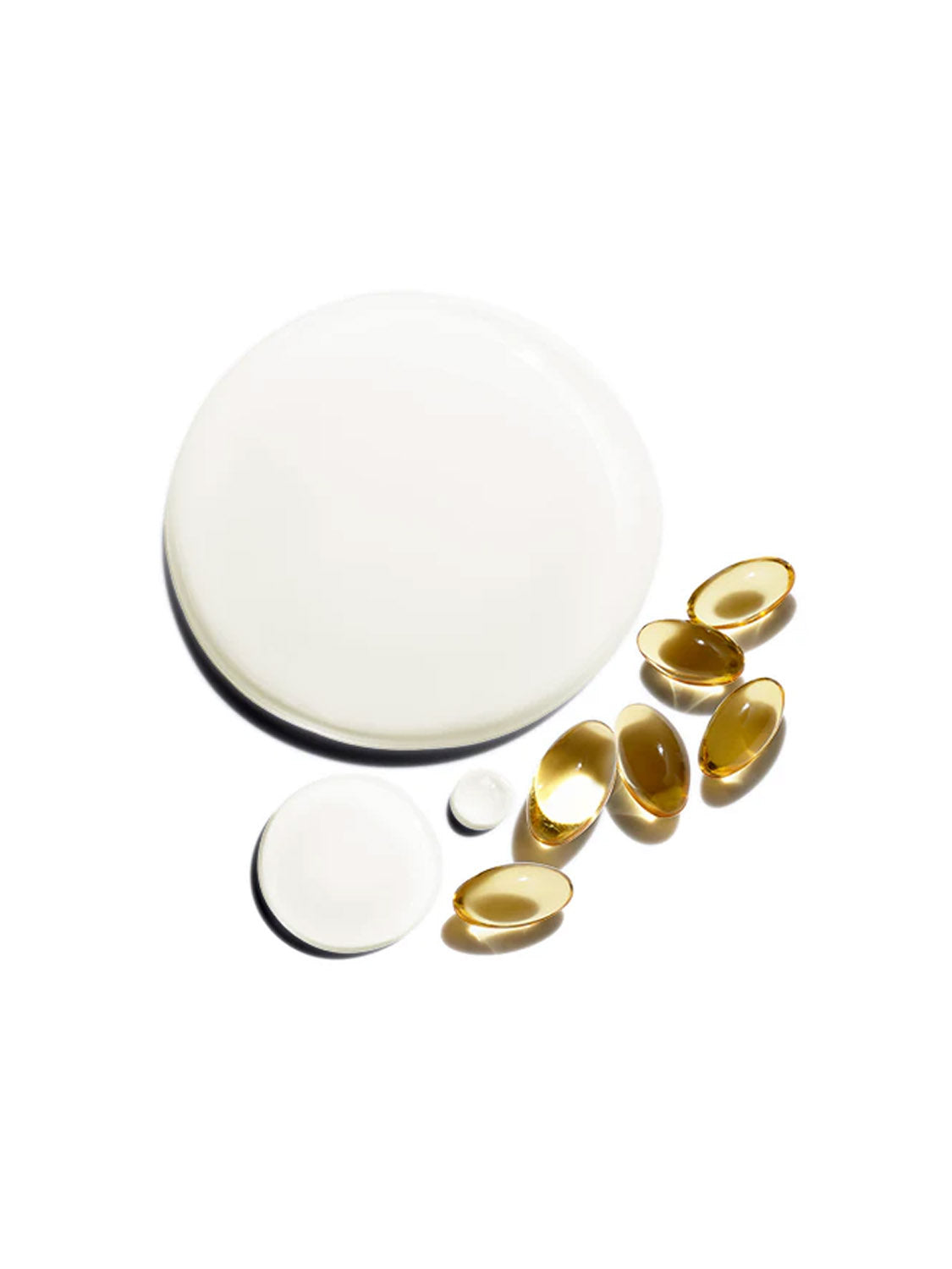 Jack Black Beard Oil is arranged on a white background as six golden oval capsules, a large white liquid circle, two smaller white drops, and one white tablet.