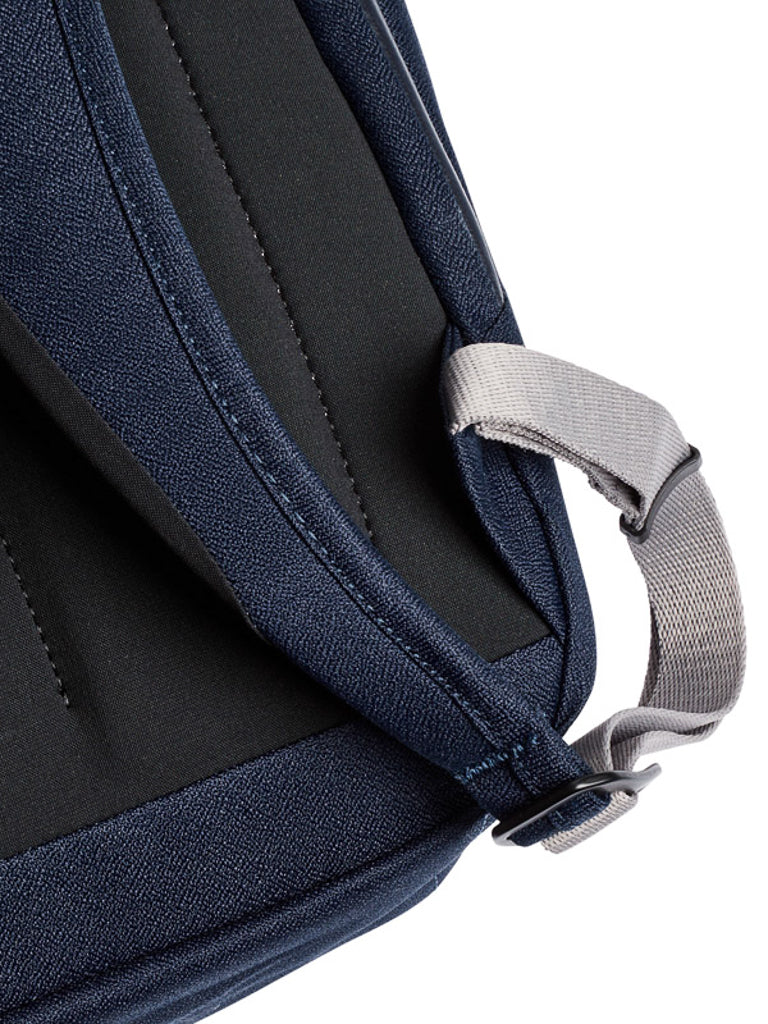 Close-up of the Bellroy Melbourne Backpack - 18L in navy, showing the gray adjustable buckle, padded back, and durable fabric—a stylish and professional choice for everyday business use.