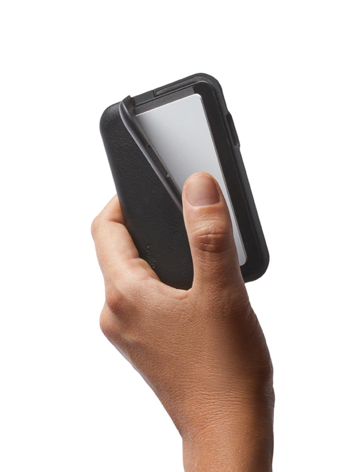 A hand holds the Bellroy Flip Case Wallet, a sleek black eco-tanned leather cardholder, partially sliding out a white card against a plain white background.
