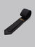 The ID Cotton Tie Berlin by ID Menswear is a black cotton tie with a subtle textured pattern, neatly rolled on a light gray background. A brown and gold brand label inside adds refined elegance to your business formal look.
