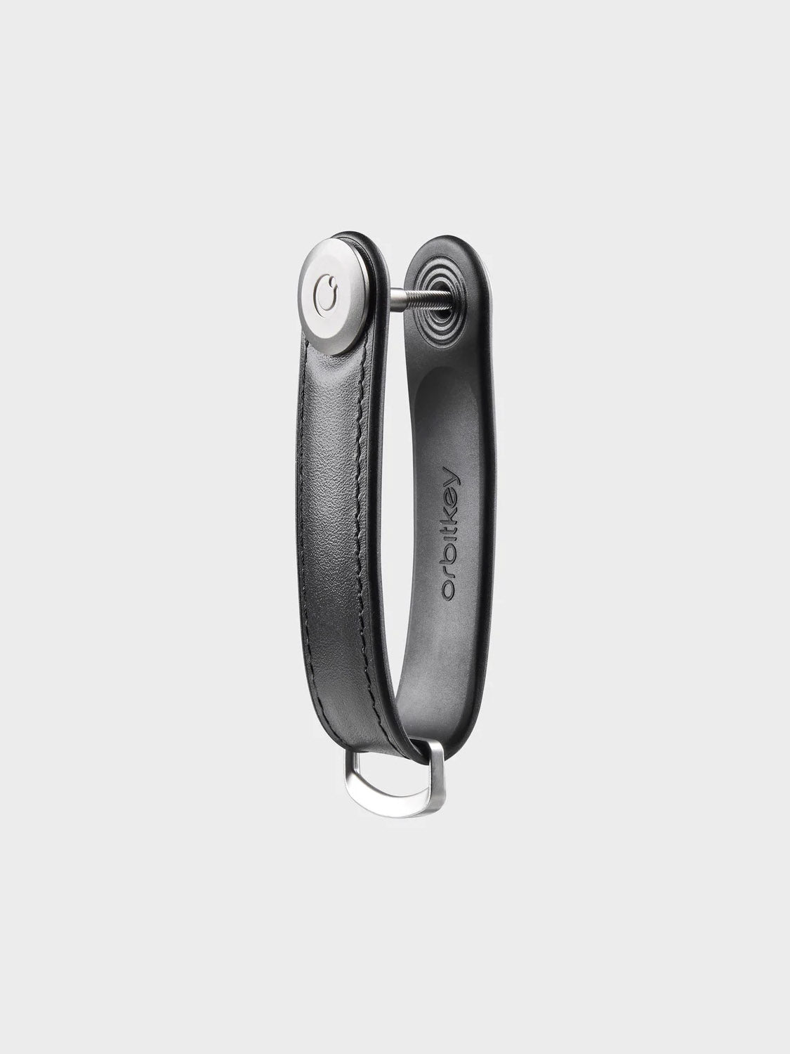 The Orbitkeys Key Organizer Hybrid Leather, in black Nappa leather with a metal button and loop, compactly organizes keys. The brand name is embossed inside and it's shown against a plain light background.
